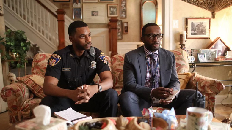 Jemell Rayam (Darrell Britt-Gibson) sits on a couch next to Jaquan Dixon (Jermaine Crawford) in We Own This City