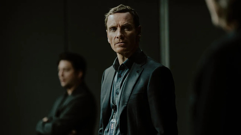 Martian (Michael Fassbender) stands grimly in the shadows in The Agency: Central Intelligence