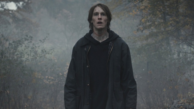 Jonas Kahnwald (Louis Hofmann) stands with his mouth agape in a foggy forest in Dark