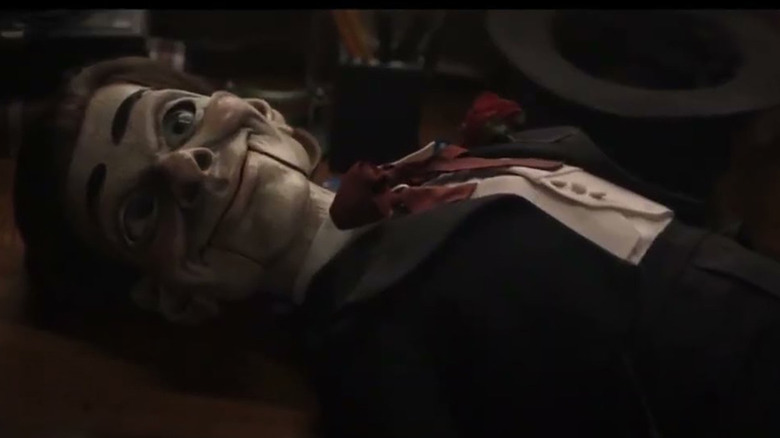 Slappy the Dummy (Chris Geere) smiles while lying down in Goosebumps (2023)