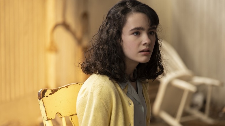 Lilly Bainbridge (Clara Stack) sits distraught on a chair in It: Welcome to Derry