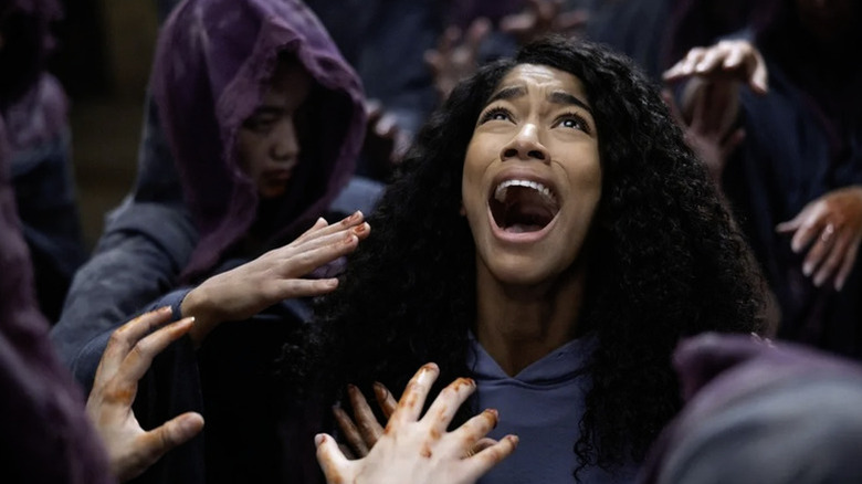 Ilonka (Iman Benson) screams as she's surrounded by cloaked corpses in The Midnight Club