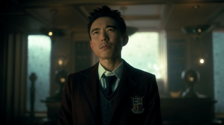 Ben Hargreeves (Justin H. Min) stares up quizzically in his academy uniform in The Umbrella Academy