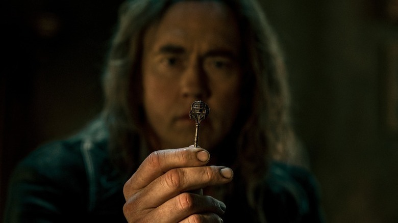 Frederick Gideon (Kevin Durand) stares closely at a small key in Locke & Key