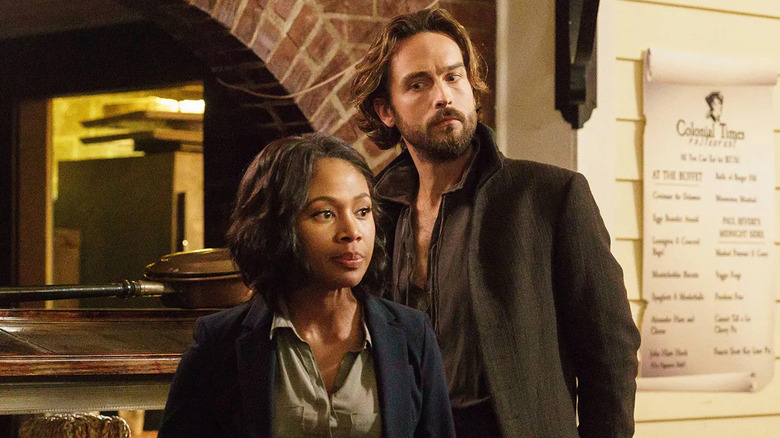 Ichabod Crane (Tom Mison) glances at Abbie Mills (Nicole Beharie) in a museum in Sleepy Hollow