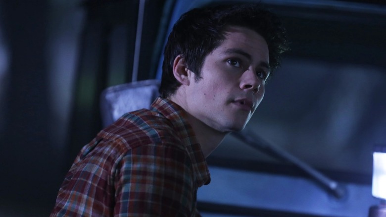 Stiles Stilinski (Dylan O'Brien) stares up from a pickup truck in Teen Wolf
