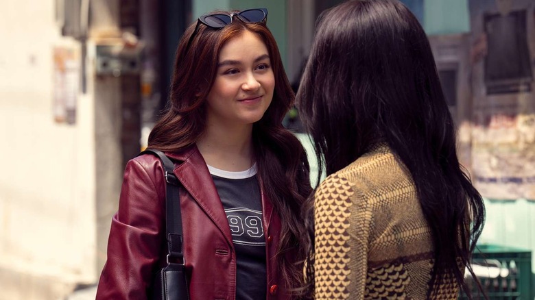Kitty wearing sunglasses and a red leather jacket smiling at someone on XO, Kitty