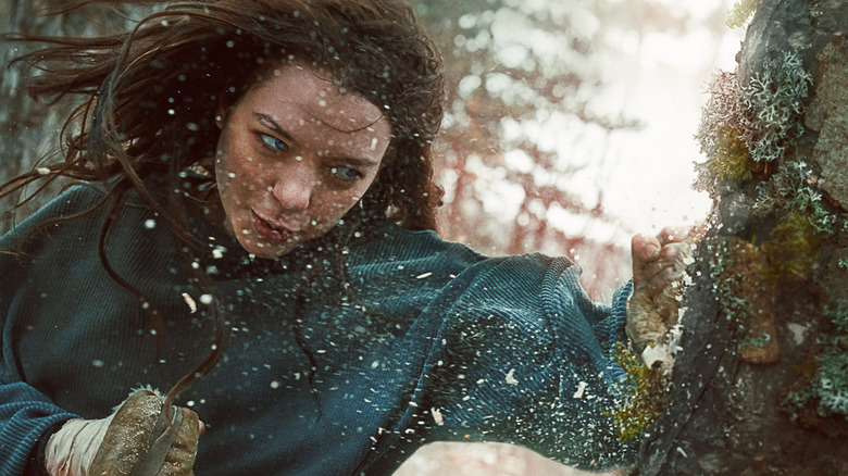 Esme Creed-Miles as Hanna punches a tree in Hanna