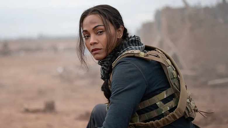Zoe Saldana as Joe crouches on a battlefield in Special Ops: Lioness