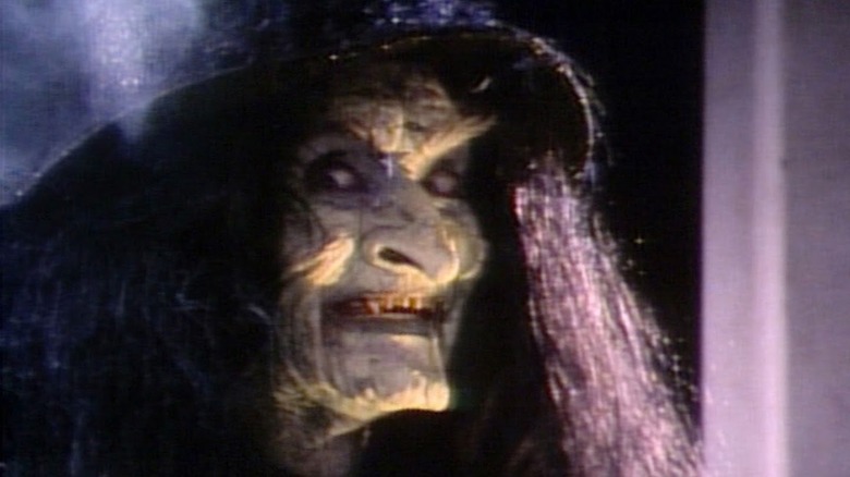 A witch (Frances Chaney) gives an evil smile in Tales from the Darkside episode Trick or Treat