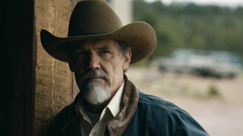 Royal Abbott (Josh Brolin) stands by a cabin in the shadows in Outer Range