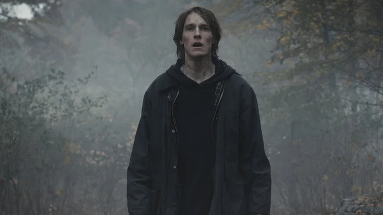 Jonas standing in foggy woods in Dark