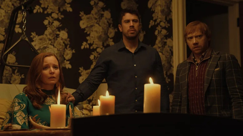 Dorothy, Sean, and Julian standing next to a table with candles in Servant