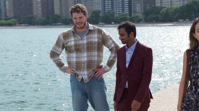 Chris Pratt as Andy, Aziz Ansari as Tom, and Natalie Morales as Lucy walking along the water in Chicago in Parks and Recreation