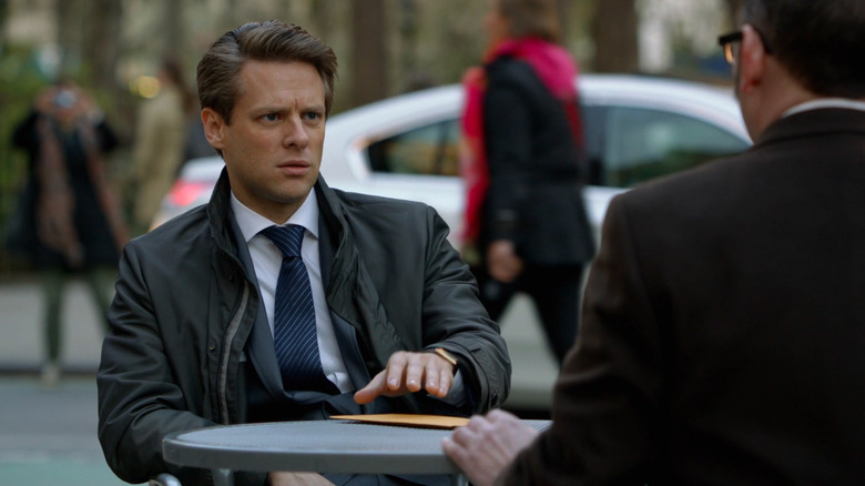 Jacob Pitts as Henry Pick outside sitting across from Michael Emerson as Harold Finch (face not pictured) in Person of Interest