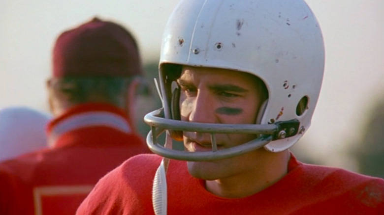 Scott Bakula as Sam Beckett wearing football helmet and red jersey in Quantum Leap
