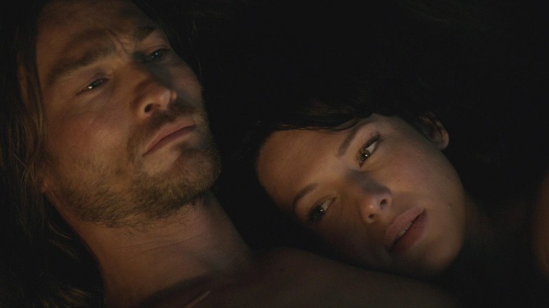 Andy Whitfield and Erin Cummings as Spartacus and Sura laying together in Spartacus