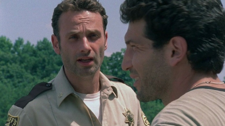Andrew Lincoln as Rick Grimes looking at Jon Bernthal as Shane in The Walking Dead