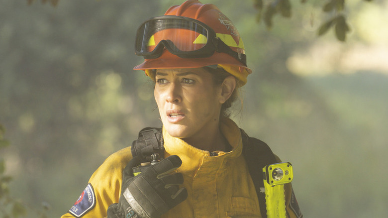 Jaina Lee Ortiz as Andy in yellow firefighter gear in "Station 19."
