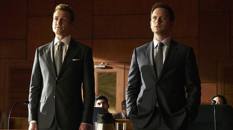 Gabriel Macht as Harvey standing next to Patrick J. Adams as Mike standing in courtroom in "Suits."