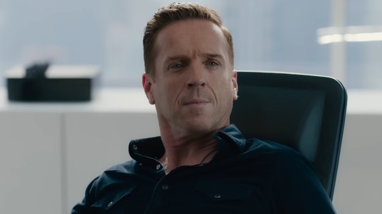 Bobby Axelrod sitting at his desk and knitting his brows on Billions