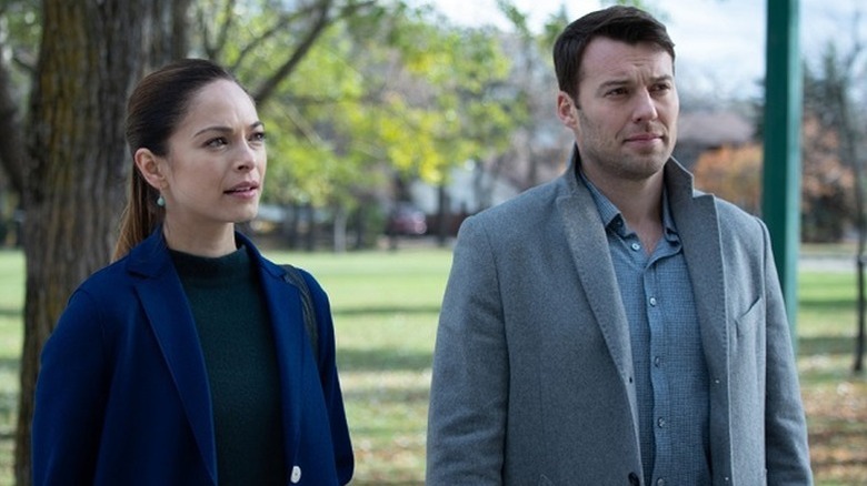 Kristin Kreuk as Joanna standing next to Peter Mooney as Billy in Burden of Truth