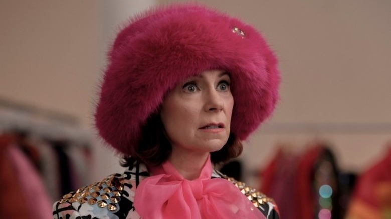 Carrie Preston as Elsbeth in enormous fluffy pink hat in Elsbeth