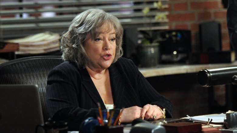 Kathy Bates as Harry sitting at desk in Harry's Law