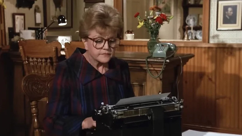 Angela Lansbury as Jessica Fletcher sitting at typewriter in Murder, She Wrote