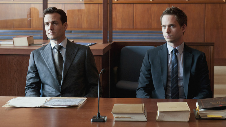 Patrick J. Adams as Mike sitting to Gabriel Macht as Harvey Spector in Suits