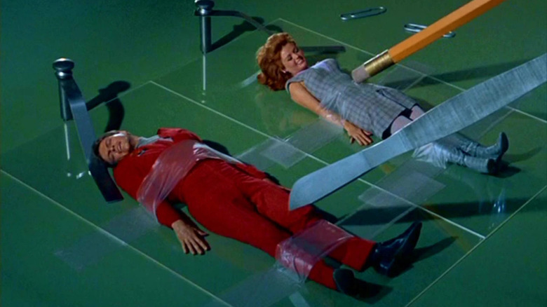Steve and Valerie get pinned down and taped, while poked with a giant pencil