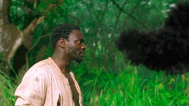 Mr. Eko looking at the smoke monster