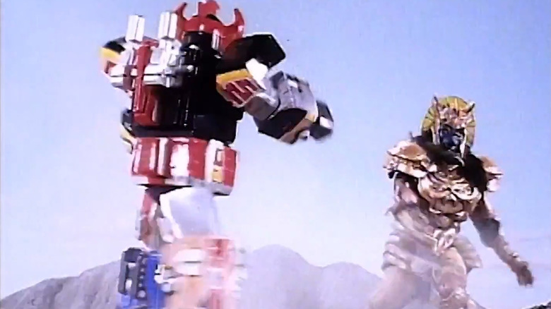 The Dino Megazord fighting an upsized Goldar