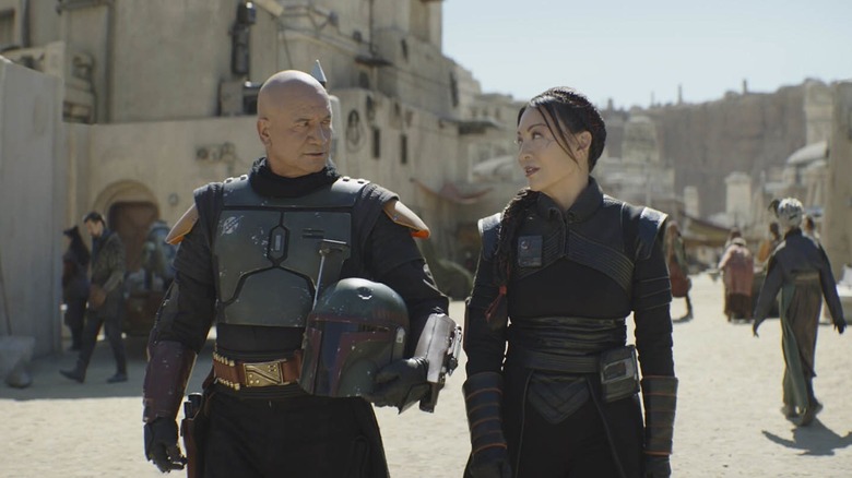 Boba Fett and Fennec Shand walk the streets of Mos Espa