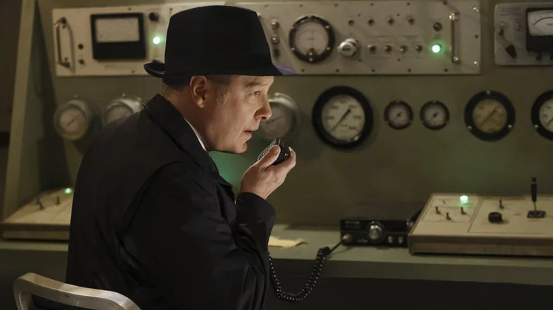 James Spader's Red Reddington holding a radio microphone on The Blacklist