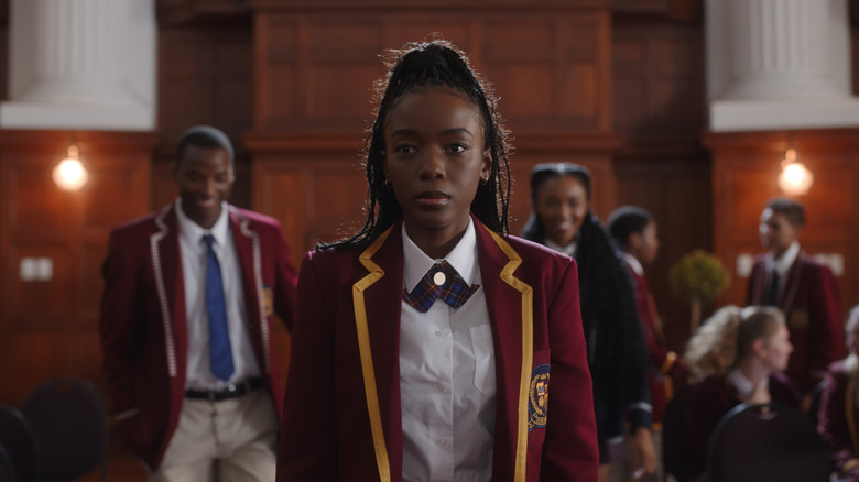 Ama Qamata as Puleng in red school uniform with classmates behind her in Blood & Water