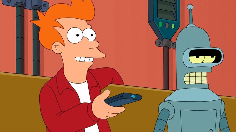 Philip J. Fry sits on a couch with a remote next to Bender in Futurama