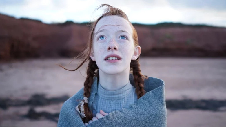 Anne looking up while wrapped in a blanket