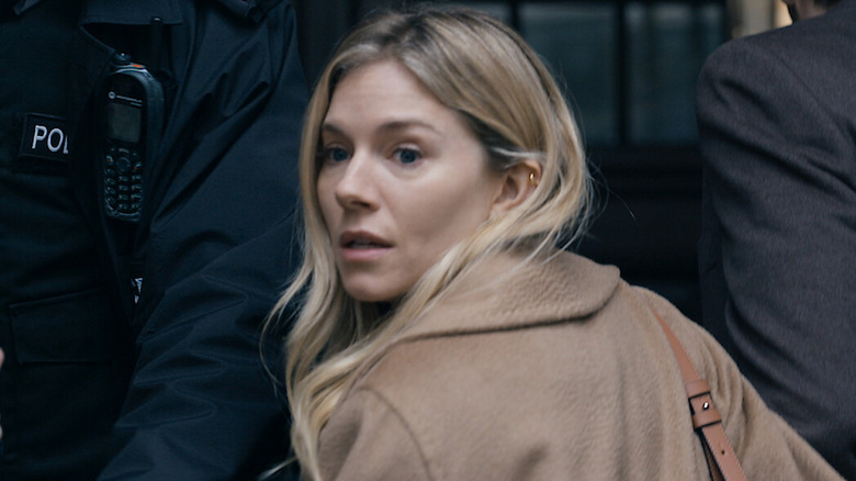 Sienna Miller as Sophie looking scared while turning back in Anatomy of a Scandal