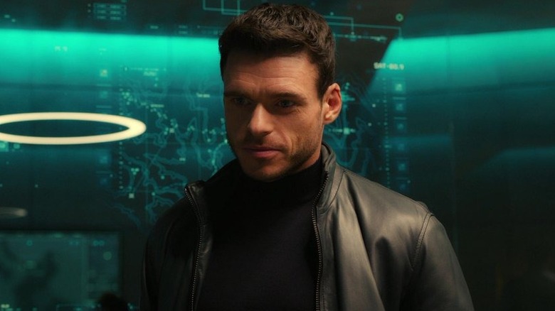 Richard Madden as David Budd wearing a leather jacket and smiling in Bodyguard