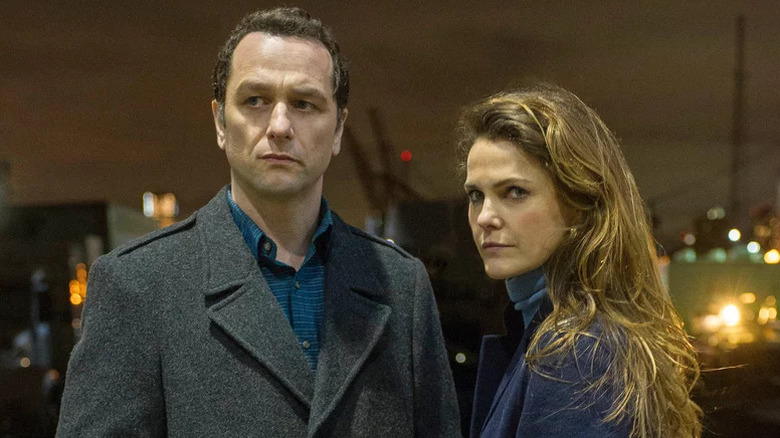 Matthew Rhys and Keri Russell as Philip and Elizabeth standing outside at night in The Americans