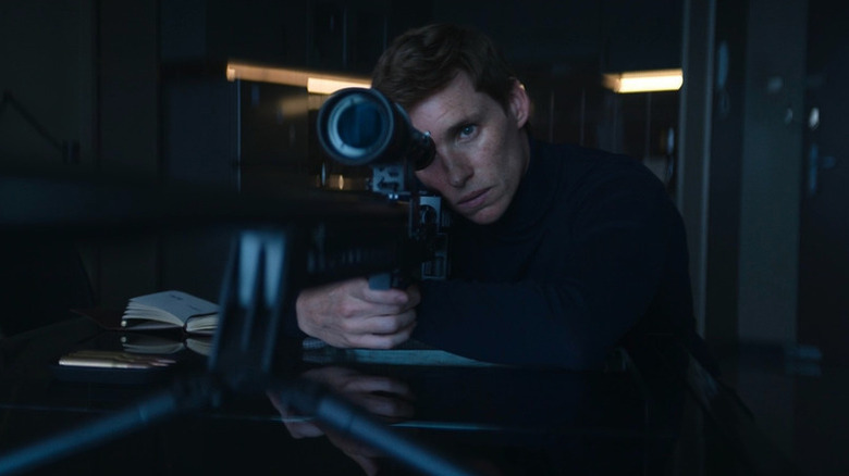 Eddie Redmayne as the Jackal looking through a sniper lens in The Day of the Jackal