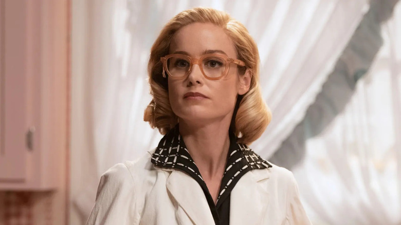 Brie Larson as Elizabeth Zott wearing glasses and a lab coat in "Lessons in Chemistry."