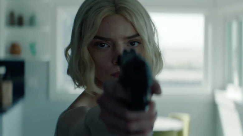 Anya Taylor-Joy as Lucky holding a gun at the camera in "Lucky."