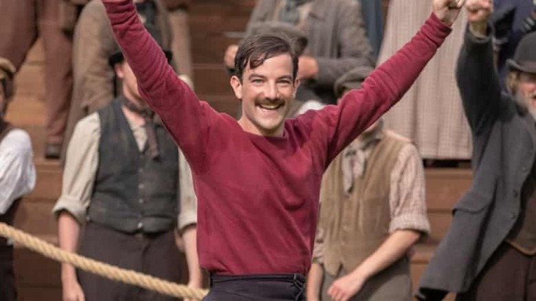 Kevin Guthrie as Fergus Suter raising his arms in "The English Game."