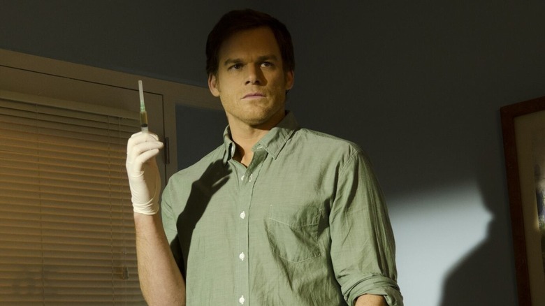 MIchael C. Hall as Dexter Morgan, holding a syringe in Dexter.