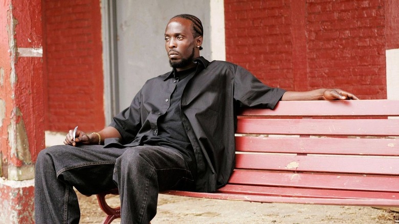 Michael K. Williams as Omar Little, sitting on a bench in The Wire.