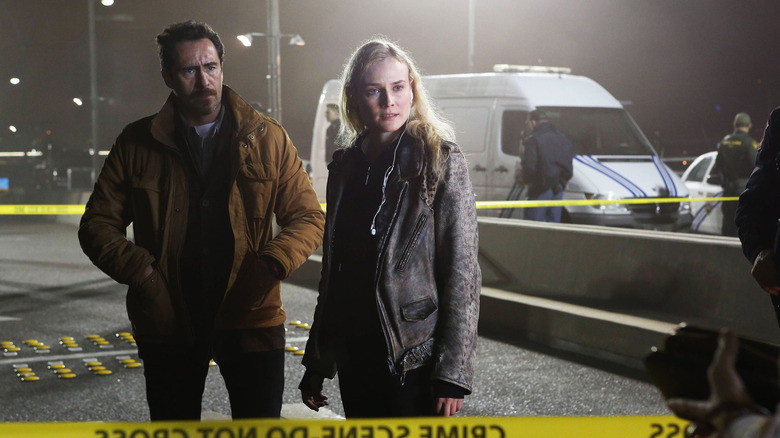 Demián Bichir as Marco Ruiz and Diane Kruger as Sonya Cross, standing at a police line in The Bridge.