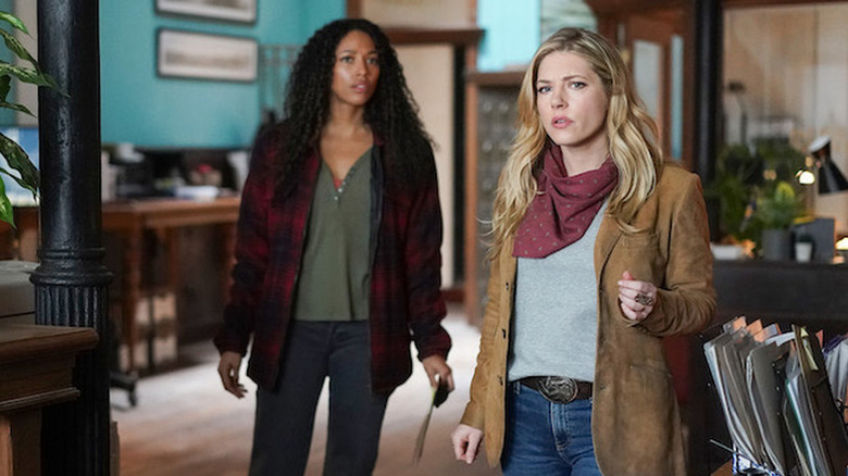 Cassie Dewell (Kylie Bunbury) and Jenny Hoyt (Katheryn Winnick) stand warily in an office in Big Sky