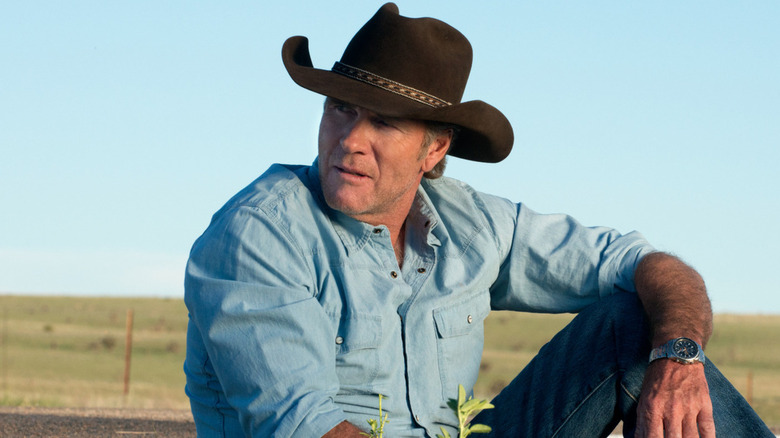 Walt Longmire (Robert Taylor) sits in an open field in Longmire